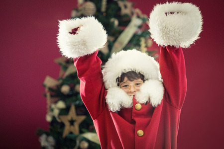 Young boy wearing Santa Claus costume at homeの写真素材