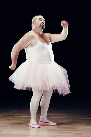 funny fat classical dancer on black backgroundの写真素材