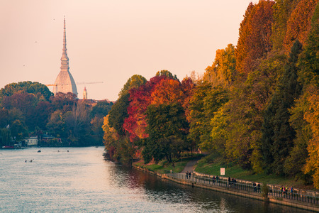po river in turin city with mole antonelliana and people walking in partの写真素材