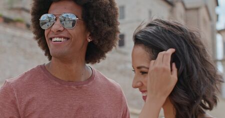 Romantic couple smiling caressing feeling free and happy to the main square in rural town of Assisi.Close shot.Friends italian trip in Umbria.4k slow motionの写真素材