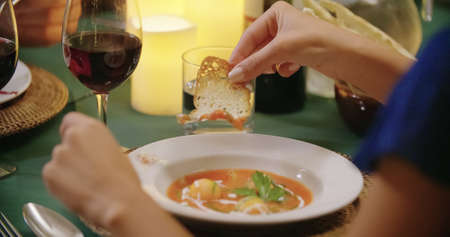 Woman hands detail while eating using fork during a romantic gourmet dinner or lunch.Wide shot. Friends italian tripの写真素材
