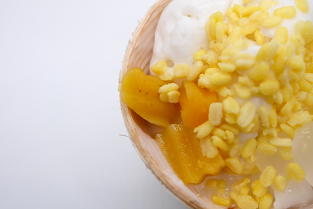 Top view and close-up of Coconut Ice Cream with soybean, nuts , Thai potato in syrup, Nipa Palm is on white backgroundの写真素材