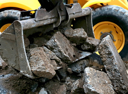 Excavator unloaded rocks and stonesの写真素材