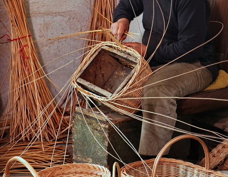 Expert craftsman while creating a basket