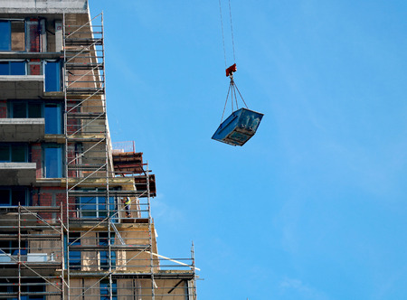 Help of the crane in the construction of the building