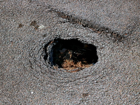 Hole  in the asphalt roadの写真素材