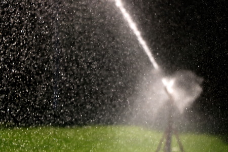Sprinkler in action watering grassの写真素材