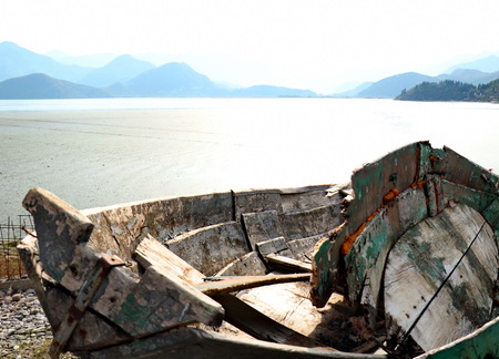Old boats on the shores of the lake   in the background of the mountainの写真素材