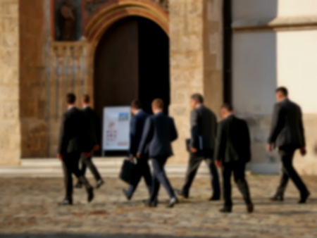 Business people walk through the city, blur