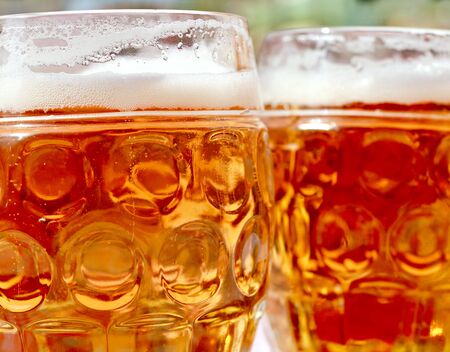 Two beer mugs at bar or pub