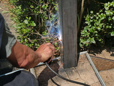 Welder welds an iron pillarの写真素材