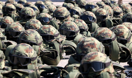 Soldiers in military uniforms and helmets at a military training ground.の写真素材