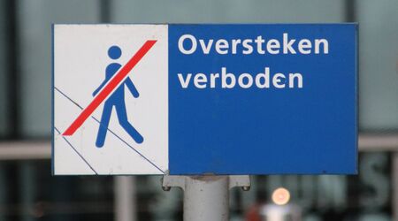 Sign at the streetcar station at Den Haag Centraal indication that crossing the tram rails is not allowedのeditorial素材