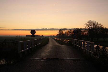 Sunrise over the meadows and water full with colors in the polder at Aarlanderveen in the Netherlandsの写真素材