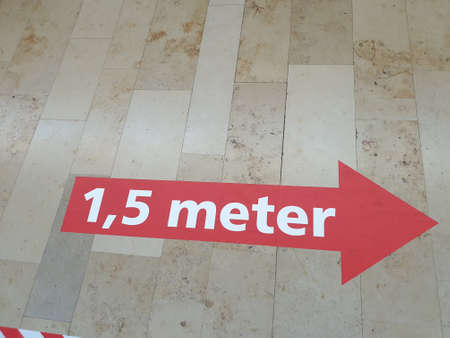 Sign of distance in shopping mall Reigerhof in Nieuwerkerk due to the corona crisis in the Netherlandsのeditorial素材
