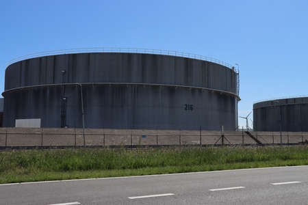 Storage tanks for crude oil or refined products like petrol or diesel at the refinery of Exxon Mobile in the botlek Harbor in the port of Rotterdam Netherlandsのeditorial素材
