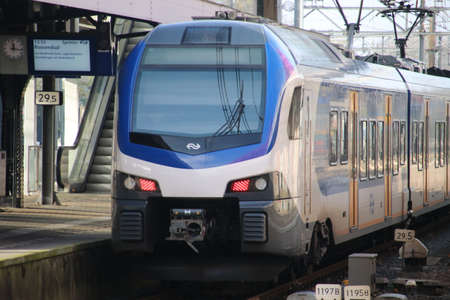 Flirt sprinter train of the NS in the Netherlands along platform at station Dordrecht in the...