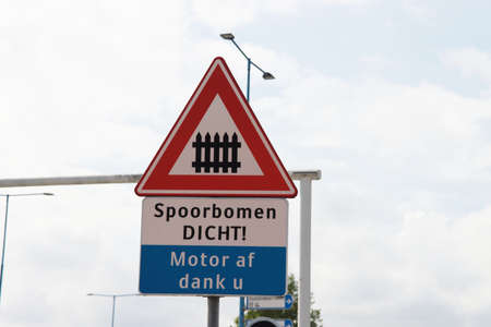 Warning sign for railroad crossing with the text that when barriers are closed the motor have to be...