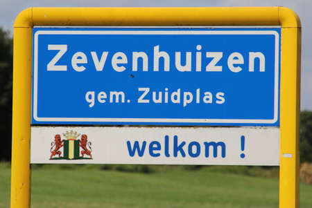 Blue and white sign of the urban area named Zevenhuizen in the Municipality of Zuidplas in the Netherlandsの写真素材