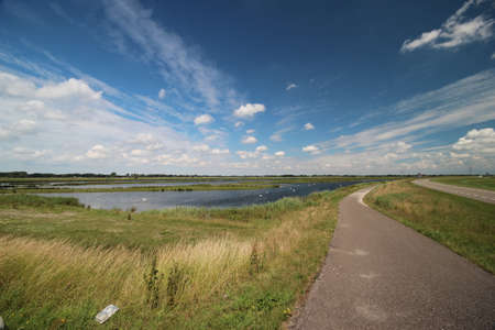 Road along owing lane in the Eendragtspolder as water storage for Rotterdam named Willem-Alexanderbaan in Zevenhuizen, the Netherlandsの写真素材