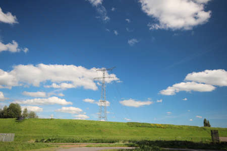 extra high masts for high voltage electricity wires over the river Hollandsche IJssel near park...