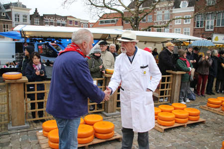 start of the touristic cheese market with children and old farmers and cheesemakers to demontrate cheese selling from the pastのeditorial素材