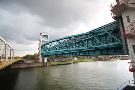 Two huge water barriers at Krimpen aan den IJssel as Hollandsche IJsselkering in the river Hollandsche IJssel with sluice to protect part of Holland agains Floodingのeditorial素材