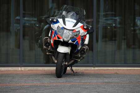 Police motorbike parked in front of the town hall of the municipality of Zuidplas in Nieuwerkerk aan...