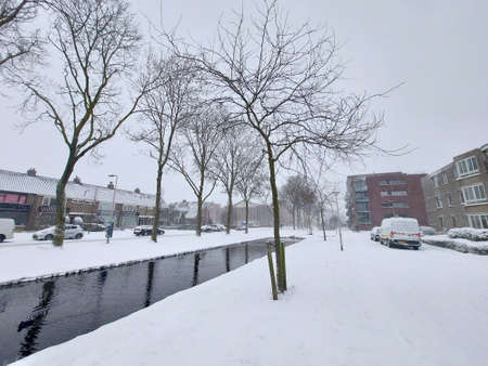 Snow on the streets and frozen water during the winter of 2021 in Nieuwerkerk aan den IJssel in the Netherlandsの写真素材
