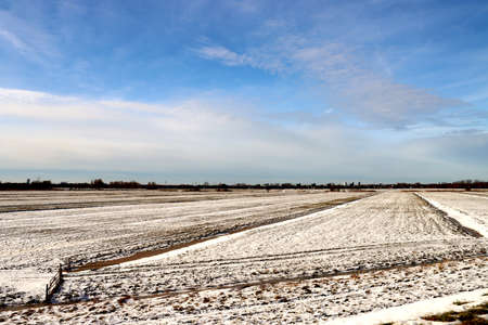 Snow on the meadows and roads in the Zuidplaspolder in the Netherlands with frozen ditches