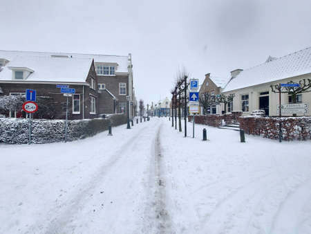 Snow on the streets and frozen water during the winter of 2021 in Nieuwerkerk aan den IJssel in the Netherlandsのeditorial素材