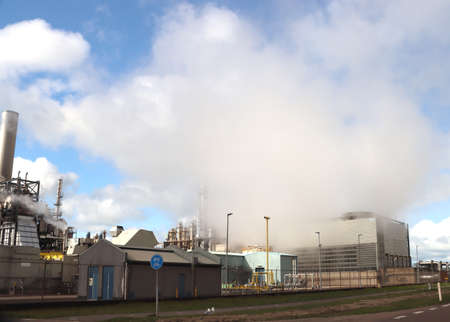 Massive steam clouds come out of a heat exchanger at Indorama plant on the Maasvlakte in the port of Rotterdamのeditorial素材