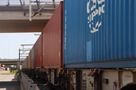 Containers on chassis pulled by Vossloh locomotive at the Pernis Harbor in rotterdam