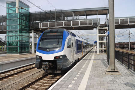 Stadler Flirt 3 local commuter train of NS at station Lage Zwaluwe in the Netherlandsのeditorial素材