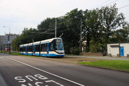 Blue and white Urbos 100 CAF tram run on line 5 by GVB at Amsterdam Zuid station