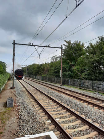 Old museum steam train on track between Rotterdam and Gouda in the Netherlands