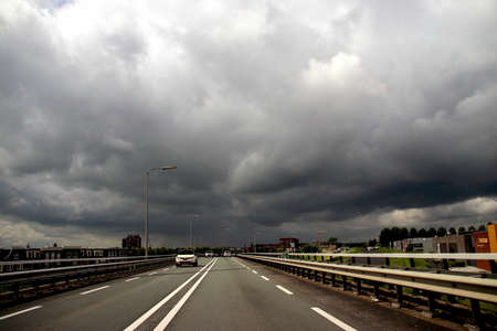 Dark cumulus clouds above the N207 road at Gouda