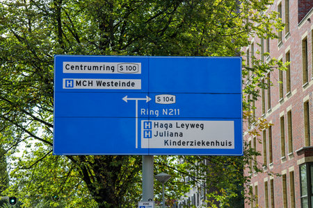 Dutch direction sign in blue and white heading to the two big Hospitals in The Hague Westeinde and Haga Leyweg and also to Juliana childrens Hospitalのeditorial素材
