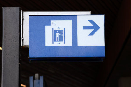 Direction sign to the elevator on railway station Lansingerland-Zoetermeer in the Netherlandsのeditorial素材