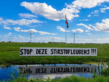 Protest signs and rows of flags upside down in Lekkerkerk along the N210 in the municipality of Krimpenerwaard the Netherlandsのeditorial素材