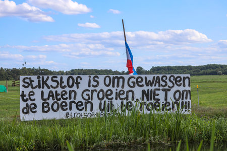 Protest signs and rows of flags upside down in Lekkerkerk along the N210 in the municipality of Krimpenerwaard the Netherlandsのeditorial素材