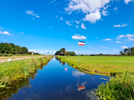 Protest signs and rows of flags upside down in Lekkerkerk along the N210 in the municipality of Krimpenerwaard the Netherlandsのeditorial素材