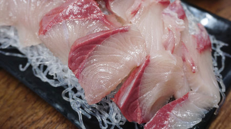 a plate of raw fishの写真素材