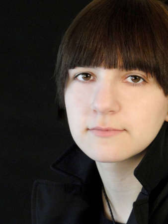 Portrait of a young girl isolated on black.の写真素材