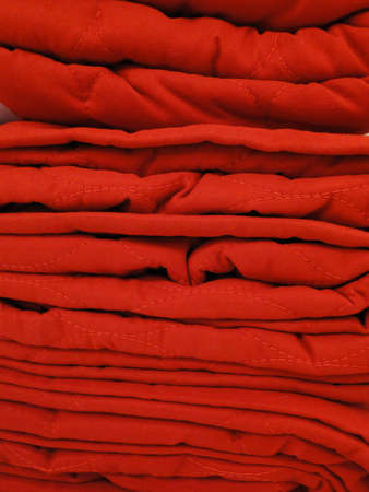 Red towels stacked filling the frame.