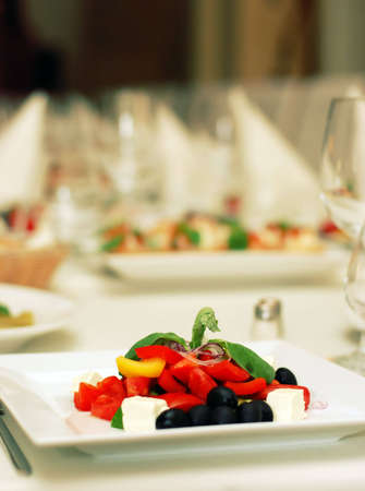 Healthy green salad on white plate in luxury restaurabt