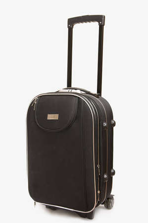 Big black travel bag (suitcase) with handle on white backgroundの写真素材