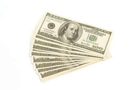 Many banknotes (100 Dollars) in pile isolated on white backgroundの写真素材