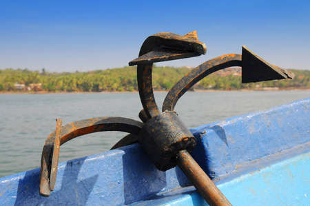 Rusty iron anchor on board a ship in open seaの写真素材