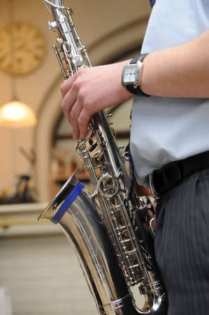 Man playing sax or brass horn (musical instrument). Hands close upの写真素材